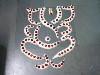 Ganpati rangoli design with  rice & betel nut.ganesha kolam.ganesha muggulu