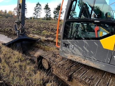 Digging A Ditch In A Large Pond